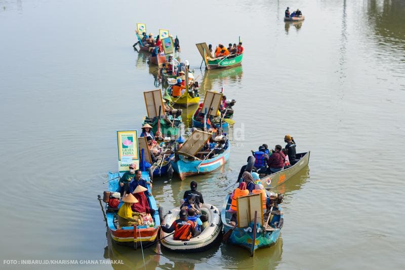 <i>Sederet penjual di Pasar Apung Semarang dan beberapa perahu yang berisi wisatawan pembeli.</i>