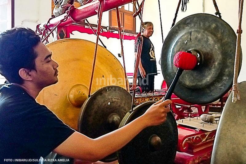 Seorang pembina Sanggar Monod Laras turut memainkan alat musik gong.