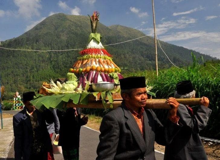 Warga membawa tumpeng yang akan didoakan bersama dalam tradisi tumpeng jangka. (Suarapemredkalbar/Antara)