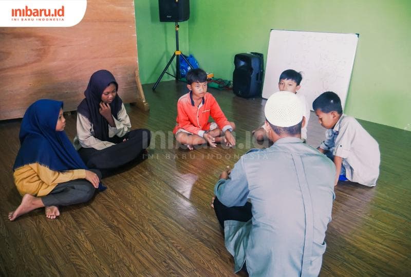 Anak-anak&nbsp;Dukuh Timbulsloko, Desa Timbulsloko, Kecamatan Sayung, Kabupaten Demak, menyimak materi pembelajaran oleh ustadz, Jumat (15/9/2023).&nbsp;(Inibaru.id/ Ayu Sasmita)