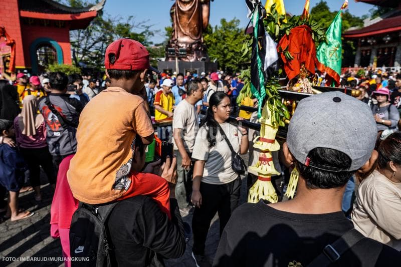 Seorang ayah memanggul anaknya untuk melihat Festival Cheng Ho di Kelenteng Sam Poo Kong.