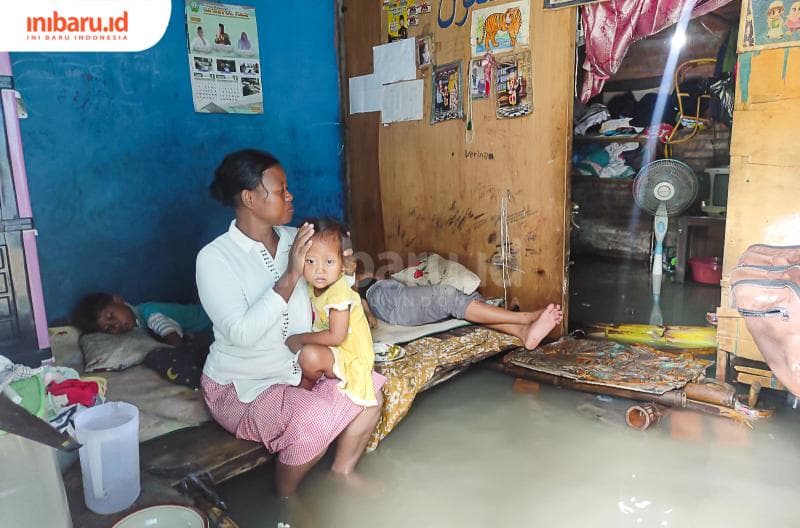 Sofiatun, warga Desa Karangrejo, Kecamatan Bonang, Kabupaten Demak bertahan di rumah dalam keadaan banjir. (Inibaru.id/ Sekarwati)