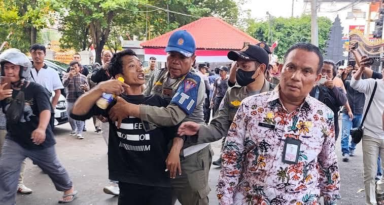 Sempat terjadi cekcok saat Satpol PP menyita donasi berupa ratusan dus air mineral di alun-alun Pati sebagai perbekalan demo, Rabu (5/8/2015). (Tribunnews)