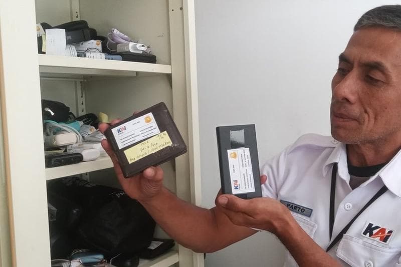 Petugas KAI menunjukkan barang-barang penumpang yang tertinggal. (Kompas/Agie Permadi)