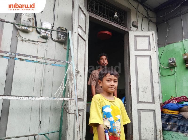 Seorang anak dan anggota keluarga lain di pintu masuk. (Inibaru.id/ Zulfa Anisah)