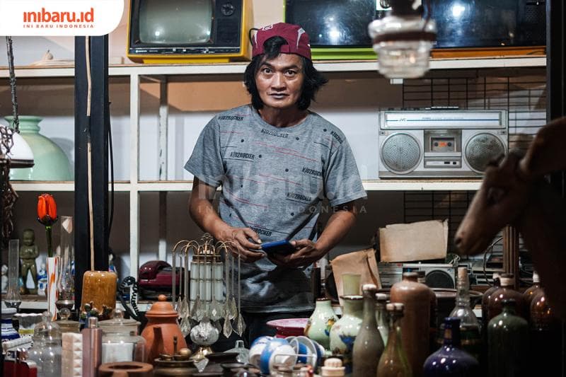 Gondrong, salah satu pedagang barang antik di Asem Kawak mengaku mulai mencoba menjual dagangannya di <i>Facebook. </i>(Inibaru.id/ Bayu N)