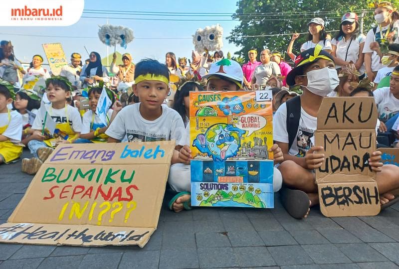 Anak-anak kecil membentangkan poster yang berisikan kegelisahan mereka terhadap kondisi bumi. (Inibaru.id/ Fitroh Nurikhsan)