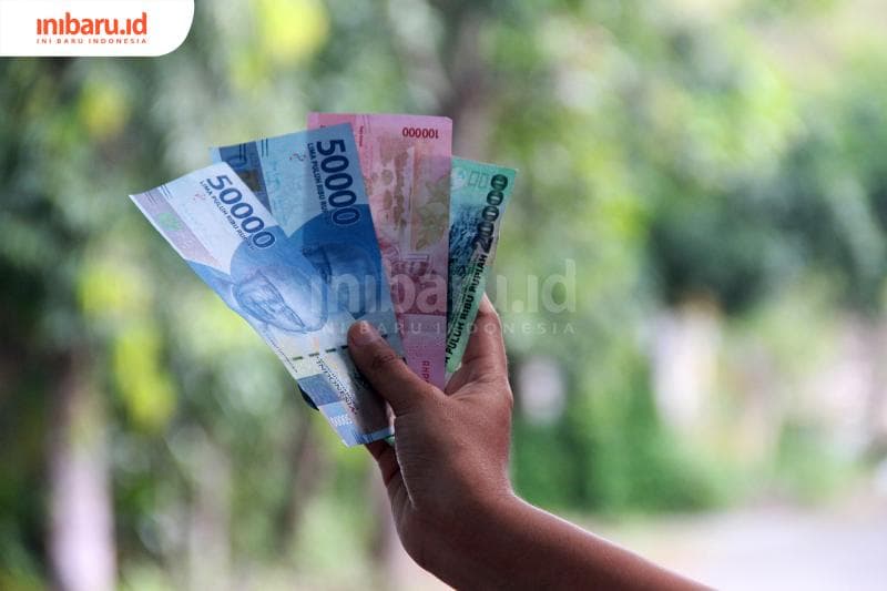 Ilustrasi uang berhutang (Inibaru.id/Triawanda Tirta Aditya)